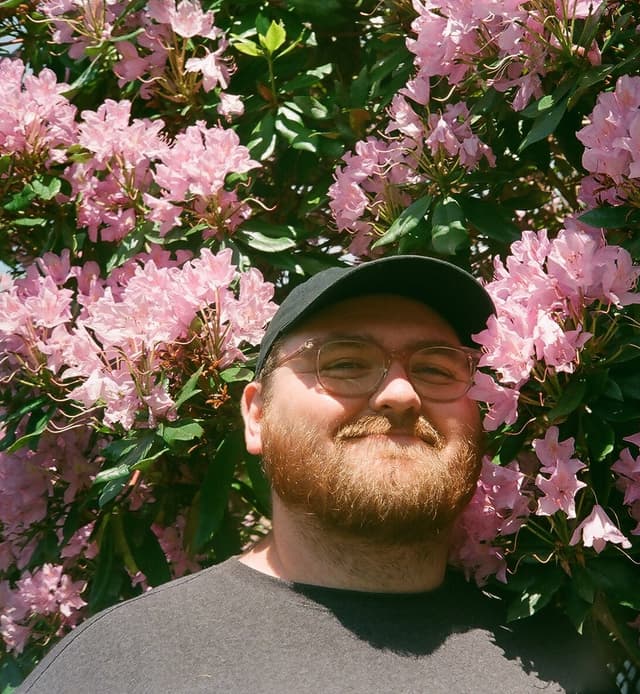 Me, standing in front of a flower bush.